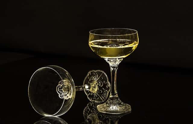 Two glasses, one empty and other full of champagne