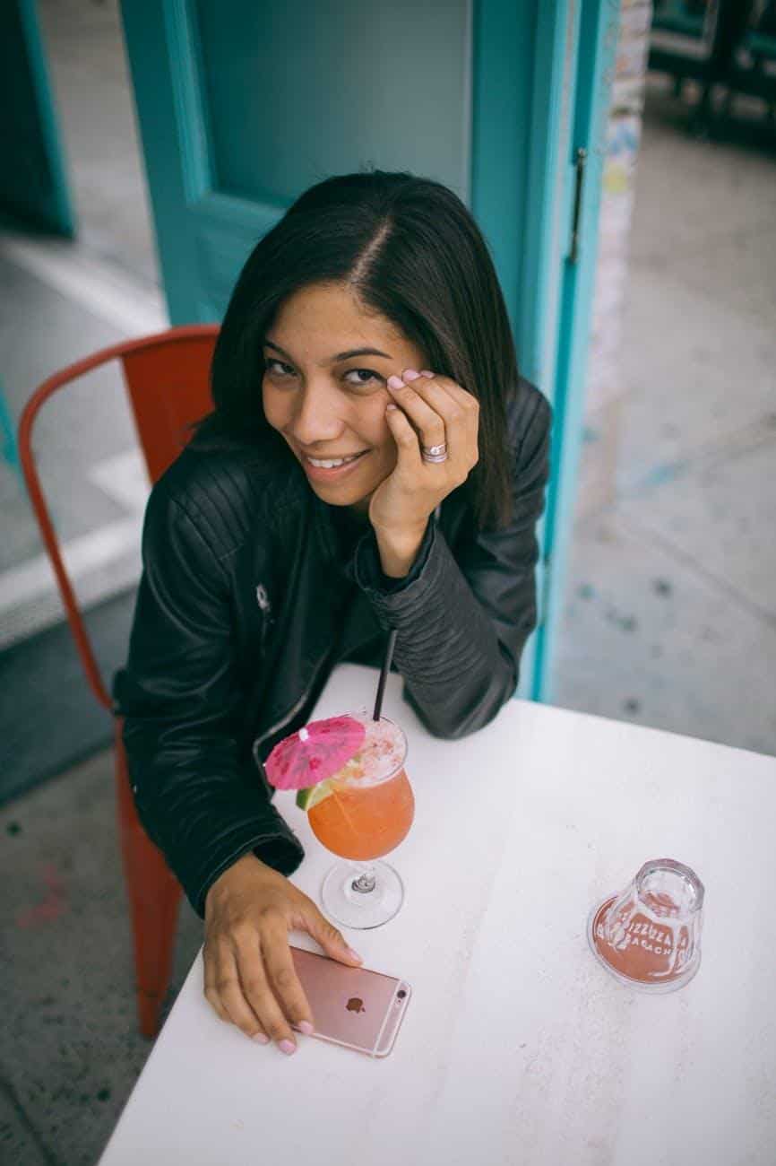 Colombian girl smiling and drinking cocktail