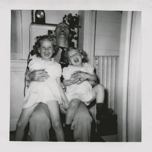 Black-white picture of father holding two daughters
