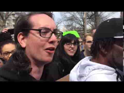 Liberal with glasses on a protest supporting "political Correctness"