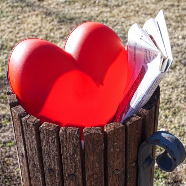 Plastic heart in a trash can
